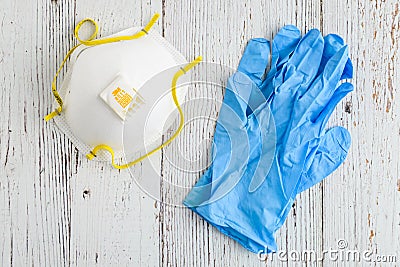 BELLEVUE, WA/USA â€“ APRIL 30, 2020: PPE on a rustic white background, 3M N95 mask and blue nitrile gloves Editorial Stock Photo